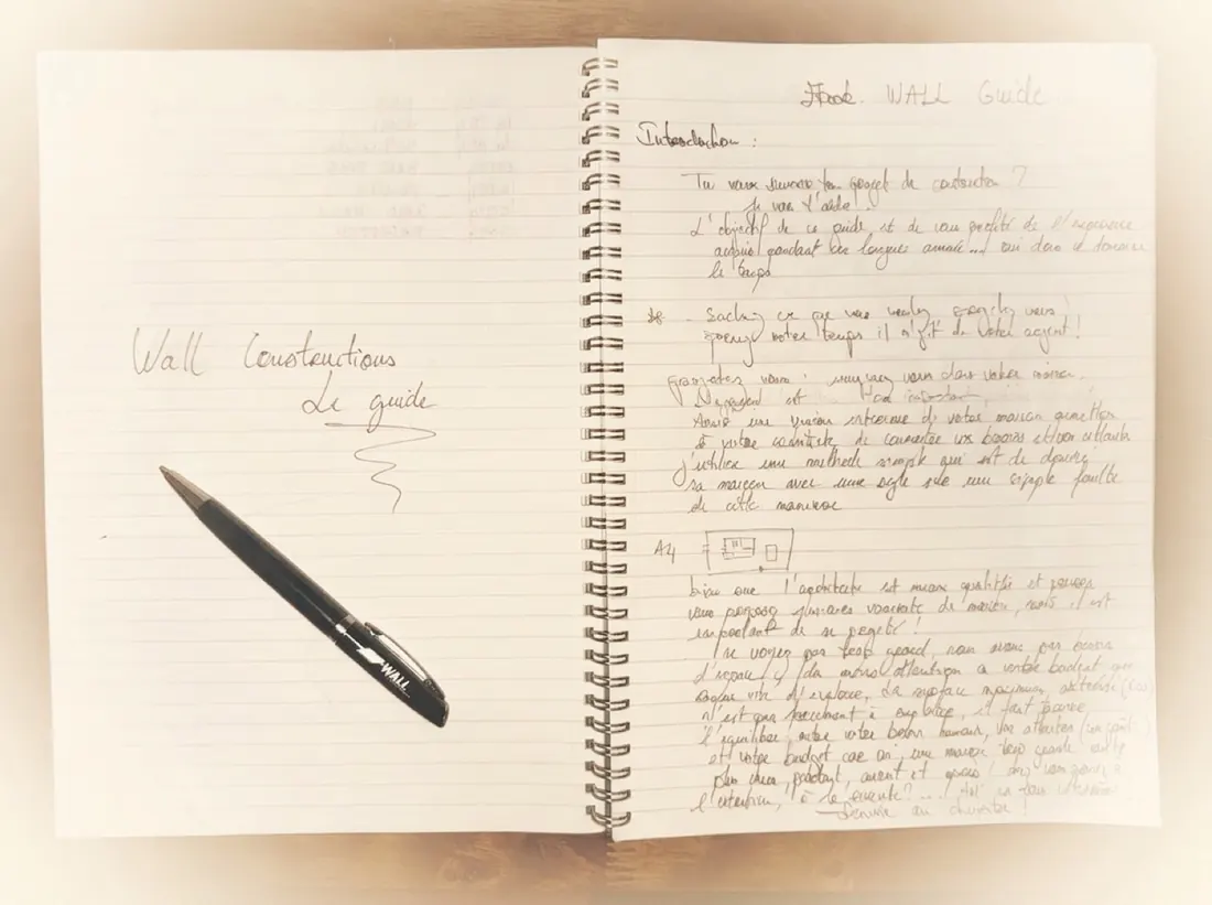 The WALL Construction guide handwritten by Badis in his notebook — proof it wasn't written by an AI