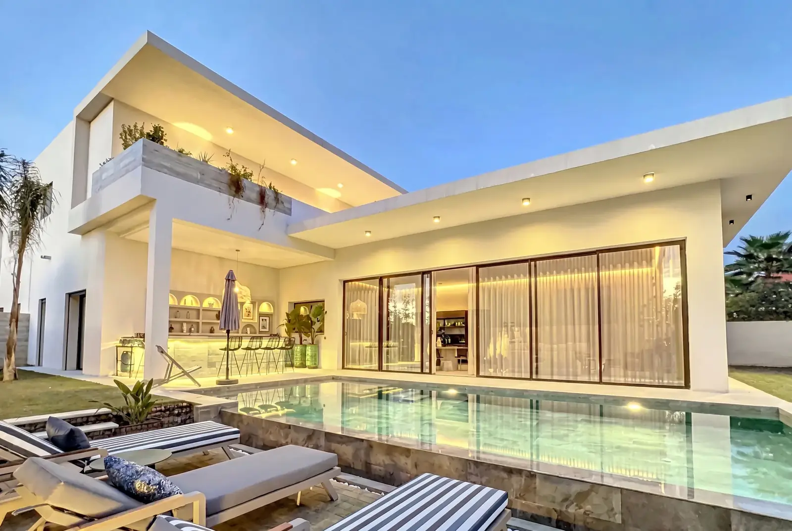 Luxury villa with pool built by WALL Construction in Marrakech, at dusk